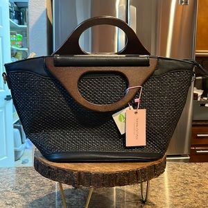 Black straw bag with wooden handles.
